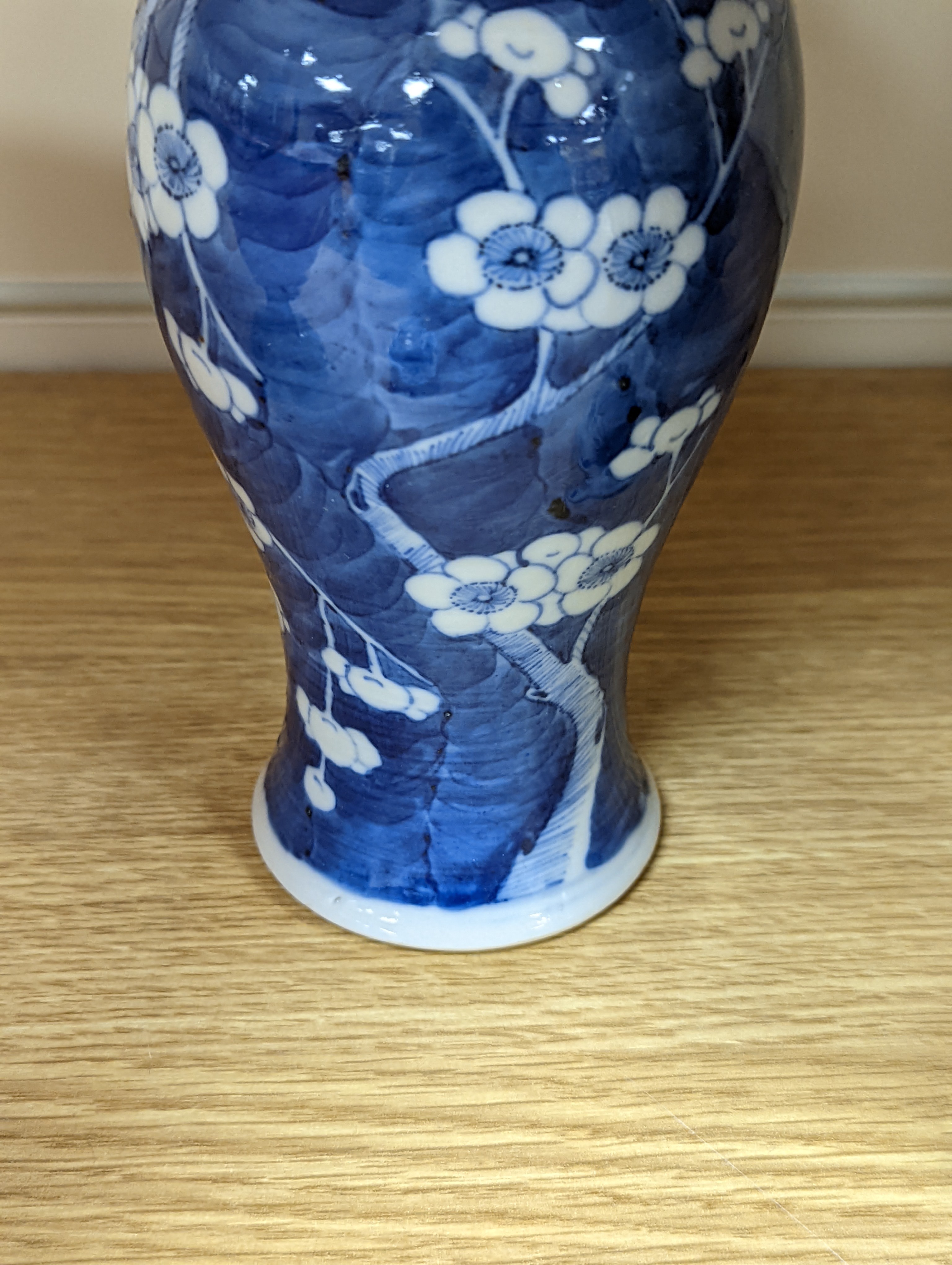 A pair of 19th century Chinese blue and white vases, a prunus vase and cover and a similar jar (4), pair of vases 24 cms high.